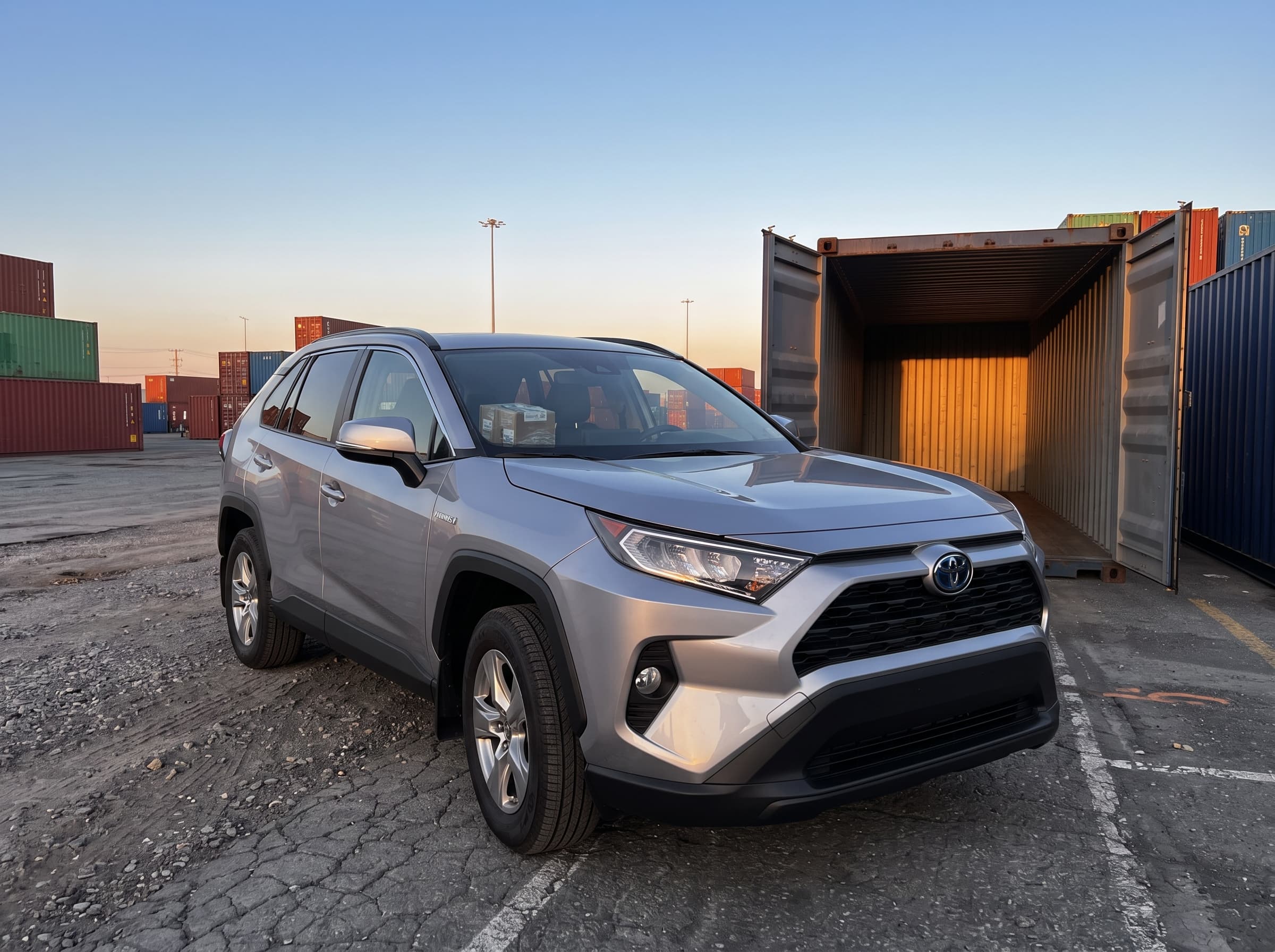 Row of used cars prepared for export shipping from Canada
